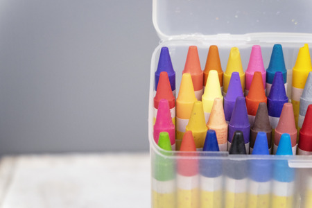 education and back to school concept, colorful crayons in the transparent box.selective focus shot and grain effectの写真素材