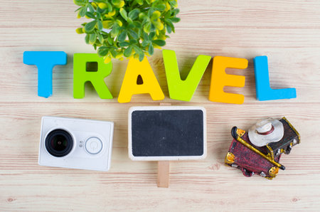 top view vacation and holiday concept word TRAVEL with accessories on wooden backgroundの写真素材