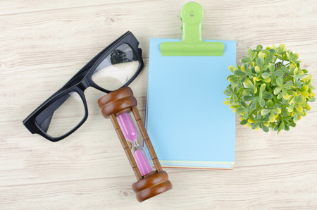 Flat lay or top view wooden office table desk with stationary. Blank notepad for text