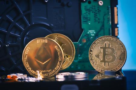 Virtual Cryptocurrency and Blockchain Technology concept, golden bitcoin on dismantle hard disk over...