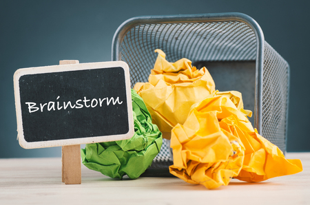 BRAINSTORM word and crumple paper spilling out from bin for inspiration and innovation conceptの写真素材