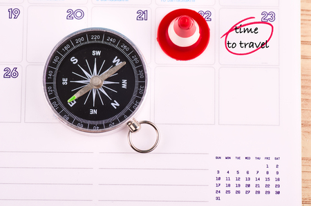 travel and vacation concept, compass on planner calendar with word TIME TO TRAVELの写真素材