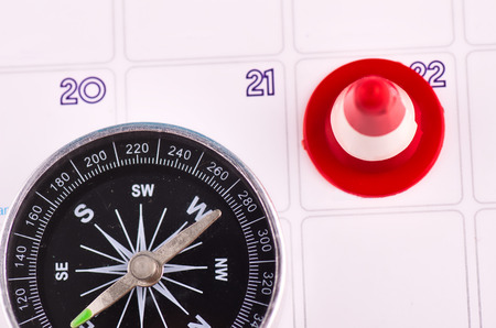 Time Planning and direction concept, close-up image of compas on planner calendarの写真素材