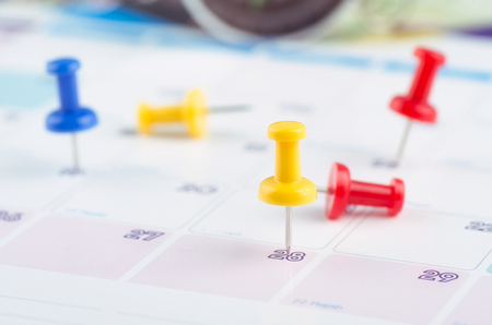 close up of colorful pin on calendar for business appointment or planning conceptの写真素材