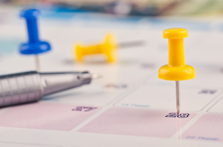 close up of colorful pin on calendar for business appointment or planning conceptの写真素材