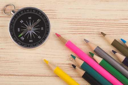compass and colorful pencil on wooden desk backgroundの写真素材