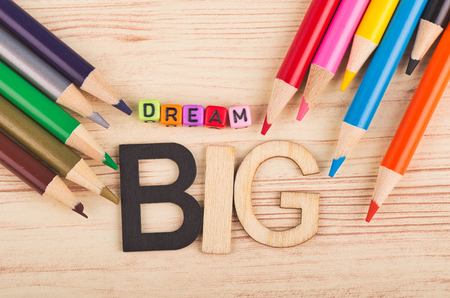 Business success concept, DREAM BIG word and colorful pencils on wooden deskの写真素材