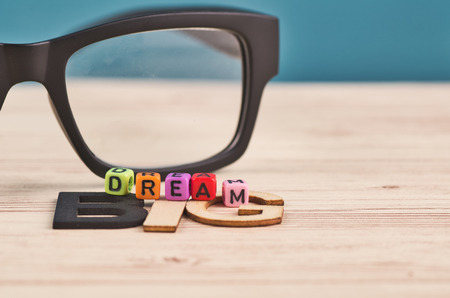Business success concept, DREAM BIG word on wooden deskの写真素材