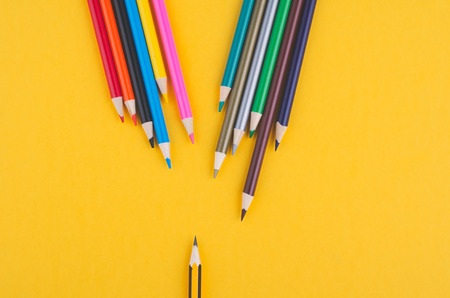 close-up image of Colourful pencils over yellow backgroundの写真素材
