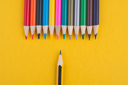 close-up image of Colourful pencils over yellow backgroundの写真素材