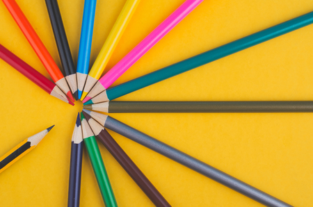 close-up image of Colourful pencils over yellow backgroundの写真素材