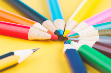 close-up image of Colourful pencils over yellow backgroundの写真素材