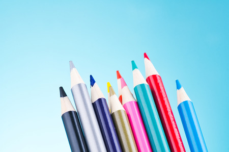 close-up image of colourful pencils over beautiful reverberation gradient backgroundの写真素材