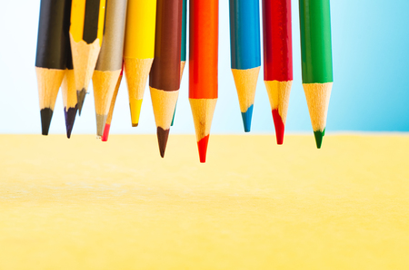 close-up image of colourful pencils over beautiful reverberation gradient backgroundの写真素材