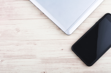 mockup image of laptop and hand phone on wooden desk workplaceの写真素材