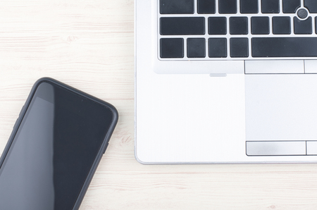 mockup image of laptop and hand phone on wooden desk workplaceの写真素材
