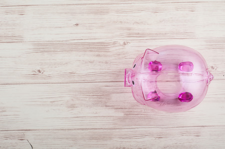 financial crisis concept, empty piggy bank over wooden backgroundの写真素材