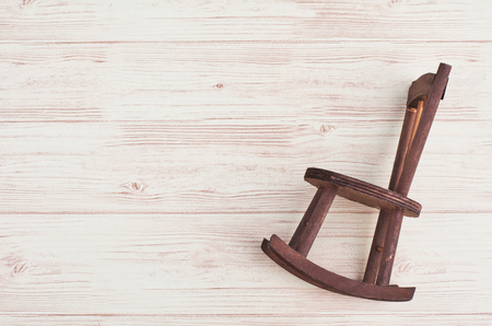 Mininature old rocking chair on wooden backgroundの写真素材