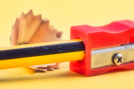 Back To school Concept, pencil with it shavings and sharpener over yellow backgroundの写真素材