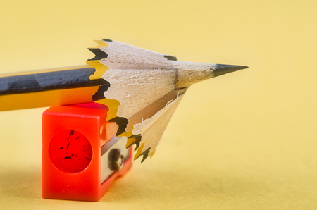 Back To school Concept, pencil with it shavings and sharpener over yellow backgroundの写真素材