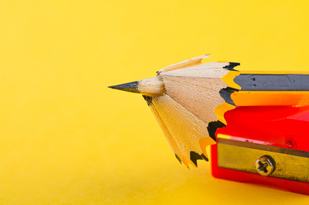 Back To school Concept, pencil with it shavings and sharpener over yellow backgroundの写真素材