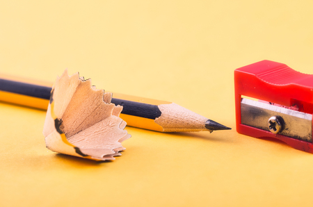 Back To school Concept, pencil with it shavings and sharpener over yellow backgroundの写真素材