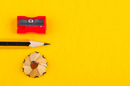 Back To school Concept, pencil with it shavings and sharpener over yellow backgroundの写真素材