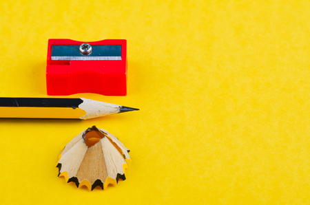 Back To school Concept, pencil with it shavings and sharpener over yellow backgroundの写真素材