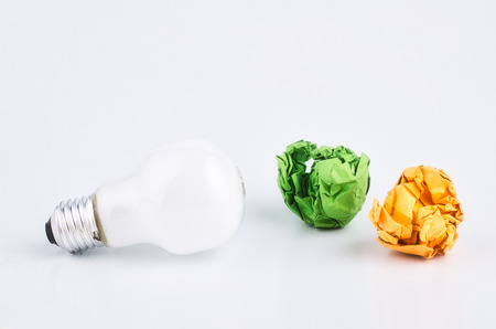 crumple paper and bulb over white background for creative ideas conceptの写真素材