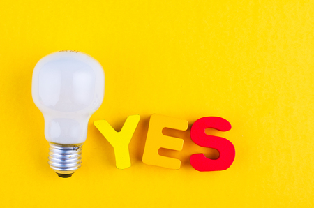 motivation to be sincere and kind concept, word YES on yellow backgroundの写真素材