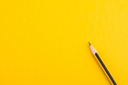 graphite wooden pencil on yellow backgroundの写真素材