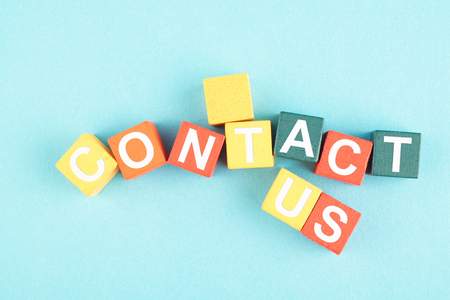CONTACT US word on wooden cube for customer support and Inquiry hotline concept.の写真素材