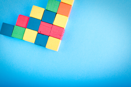 Symbol of teamwork and unity, group of wooden cube on blue background. copy space for textの写真素材