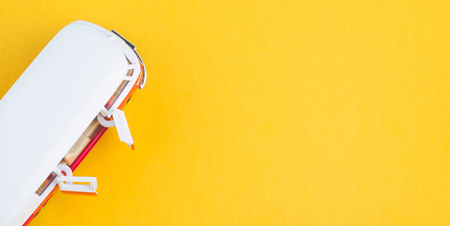 Miniature toy van on yellow background for travelling concept. copy space for textの写真素材