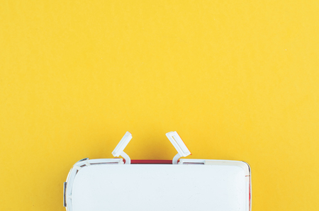 Miniature toy van on yellow background for travelling concept. copy space for textの写真素材