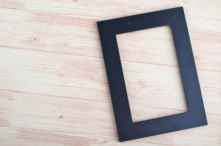 top view empty photo frame on wooden backgroundの写真素材