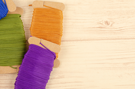 colorful stacking cotton yarn wool on wooden background. copy space for textの写真素材