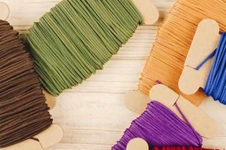 colorful stacking cotton yarn wool on wooden background. copy space for textの写真素材