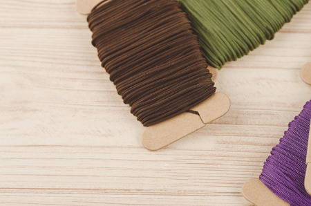 colorful stacking cotton yarn wool on wooden background. copy space for textの写真素材