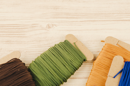 colorful stacking cotton yarn wool on wooden background. copy space for textの写真素材