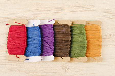 colorful stacking cotton yarn wool on wooden background. copy space for textの写真素材