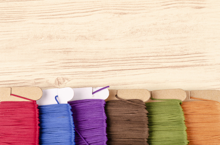 colorful stacking cotton yarn wool on wooden background. copy space for textの写真素材