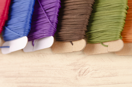 colorful stacking cotton yarn wool on wooden background. copy space for textの写真素材