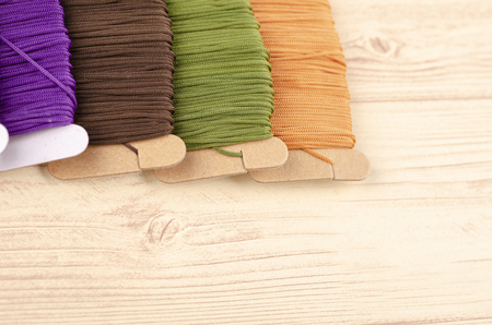 colorful stacking cotton yarn wool on wooden background. copy space for textの写真素材