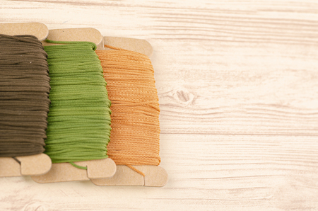 colorful stacking cotton yarn wool on wooden background. copy space for textの写真素材