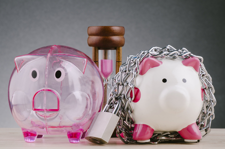financial crisis or economic depression concept, piggy bank surrounded by chains  and padlock on wooden deskの写真素材