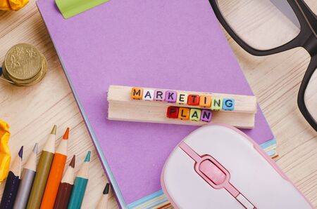 Business Campaign Concept background, colorful cube with word MARKETING PLAN on wooden deskの写真素材