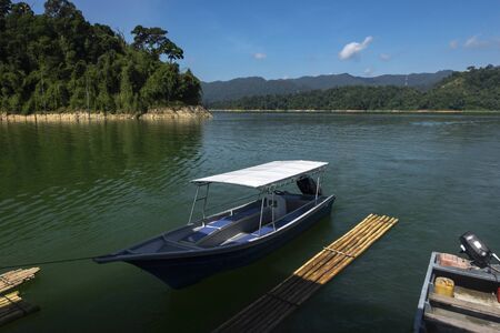 fiber speed boat floating near the boathouse.boat is main transportation at Banding Lake located in Perak State, Malaysiaの写真素材