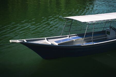 fiber speed boat floating near the boathouse.boat is main transportation at Banding Lake located in Perak State, Malaysiaの写真素材