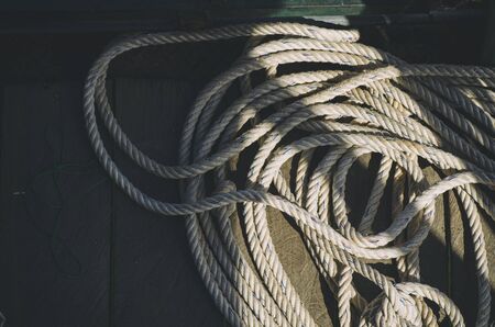 Abstract of various type of ropes and rusty deck lying on a fishing boatの写真素材